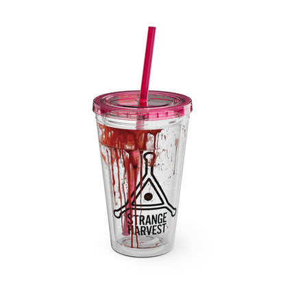 Clear tumbler with red liquid and pink lid on a white background