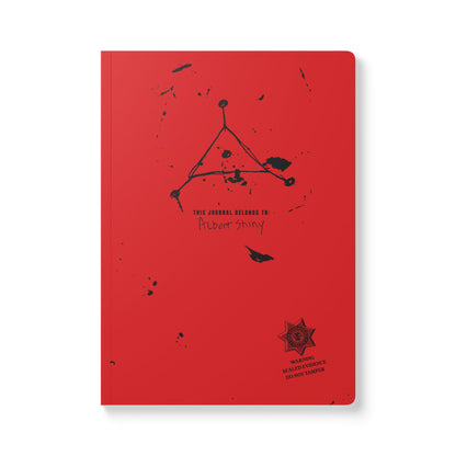 Red notebook with black text and design on a white background