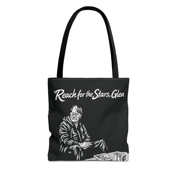Black tote bag with white graphic and text 'Reach for the Stars, Glen' on a white background