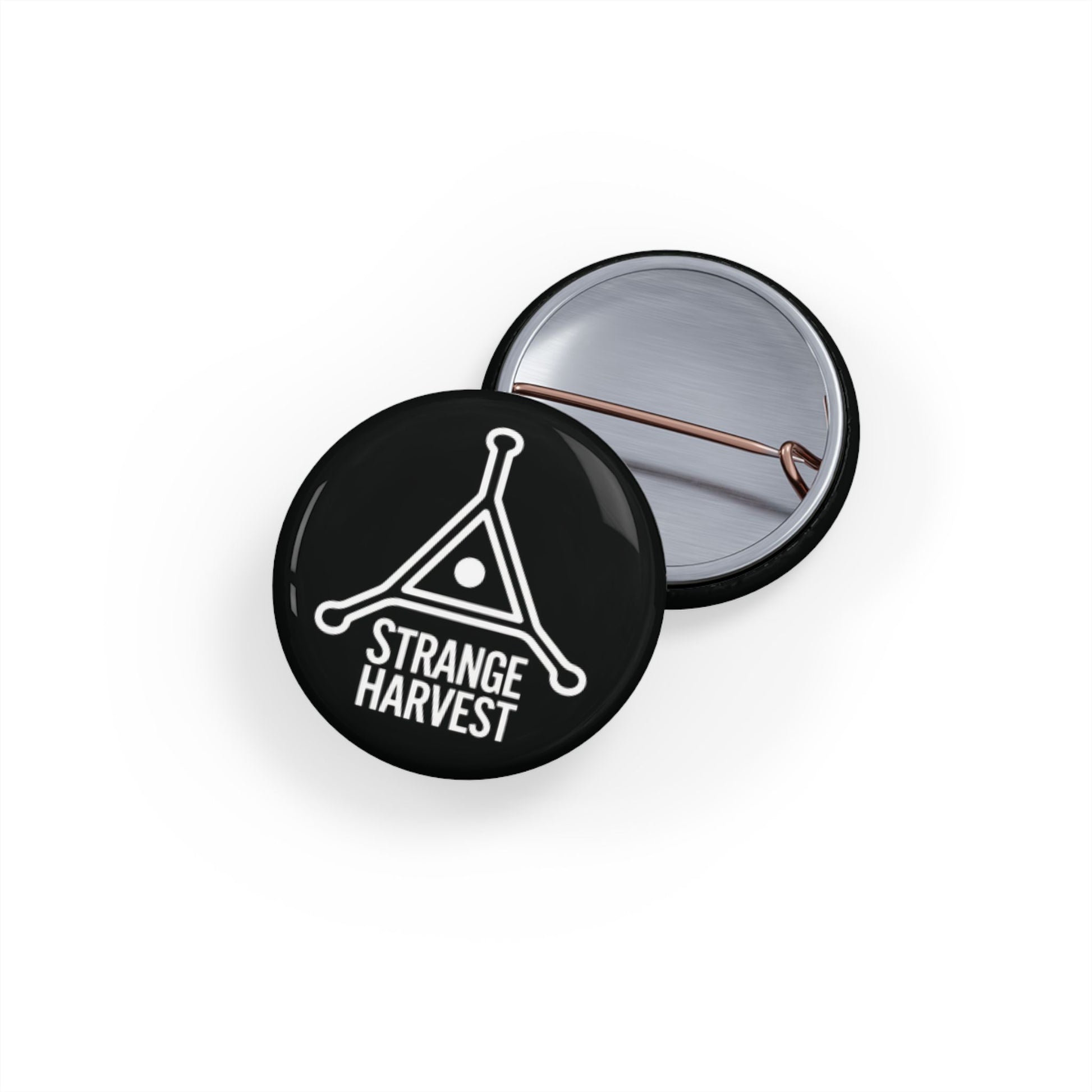 Round black button with 'Strange Harvest' logo on a white background