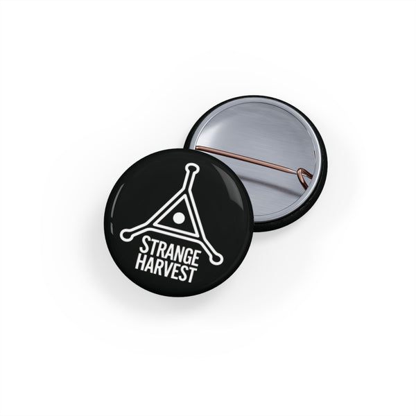 Round black button with 'Strange Harvest' logo on a white background